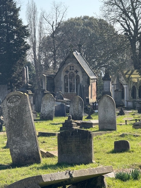 Kensal Green Cemetery — chapel with sunlit gravestones